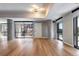 Spacious open-concept living room with concrete pillars, large windows, and hardwood floors offers natural light at 4200 W 17Th Ave # 235, Denver, CO 80204