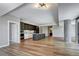 Spacious open-concept living area featuring hardwood floors, modern lighting, and kitchen island at 4200 W 17Th Ave # 235, Denver, CO 80204
