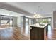Bright living room with hardwood floors, modern island, and large windows for natural light at 4200 W 17Th Ave # 235, Denver, CO 80204