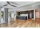Bright living room featuring wood floors, a concrete pillar, and an open layout to a modern kitchen at 4200 W 17Th Ave # 235, Denver, CO 80204