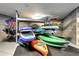 Neatly organized storage room with racks filled with kayaks, paddleboards, and life vests for outdoor adventures at 4200 W 17Th Ave # 235, Denver, CO 80204