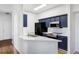 Kitchen boasts navy cabinets, quartz counters, and stainless steel appliances at 6013 Castlegate Dr # D33, Castle Rock, CO 80108