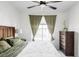 Main bedroom with king-size bed and ceiling fan at 6013 Castlegate Dr # D33, Castle Rock, CO 80108