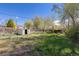 Spacious backyard with green grass and a shed offering ample storage space at 256 King St, Denver, CO 80219