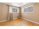 Bedroom featuring hardwood floors, two windows, and neutral wall colors at 256 King St, Denver, CO 80219