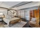 Bedroom featuring a modern bed, stylish chair and laundry equipment behind a screen at 1111 Osage St # 29, Denver, CO 80204