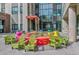 Building entrance with colorful planters and a seating area, creating a welcoming and vibrant atmosphere at 1111 Osage St # 29, Denver, CO 80204