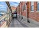Rear exterior showing brick structure, a loading dock, and parking area behind the building at 1111 Osage St # 29, Denver, CO 80204