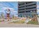 An outdoor park that shows a tall parking garage covered in solar panels at 1111 Osage St # 29, Denver, CO 80204