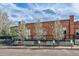 Attractive exterior of a brick building with blossoming trees and parking spaces at 1111 Osage St # 29, Denver, CO 80204