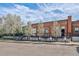 Brick building with blooming trees against a blue sky at 1111 Osage St # 29, Denver, CO 80204