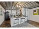 Kitchen island featuring seating and modern appliances with overhead metal grate at 1111 Osage St # 29, Denver, CO 80204
