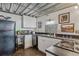 Compact kitchen with modern appliances, white cabinetry, and sleek countertops at 1111 Osage St # 29, Denver, CO 80204