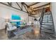 Spacious living room with concrete floors, exposed beams, open staircase, and modern furnishings at 1111 Osage St # 29, Denver, CO 80204