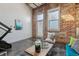 Bright living space featuring exposed brick walls, concrete floors, and lots of natural light at 1111 Osage St # 29, Denver, CO 80204