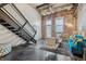 Bright living room featuring exposed brick, staircase, concrete floors, and a modern sofa at 1111 Osage St # 29, Denver, CO 80204