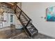 Modern industrial-style metal staircase leading to the upper floor of a stylish loft at 1111 Osage St # 29, Denver, CO 80204