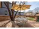 Outdoor deck with ample seating beneath a shade umbrella, perfect for relaxation and entertaining at 2673 S Cook St, Denver, CO 80210