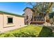 A home backyard with a detached unit, and a deck with ample space for relaxation or entertainment at 2673 S Cook St, Denver, CO 80210