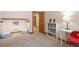 Cozy basement living area with built-in shelving, comfortable seating, and neutral carpet at 2673 S Cook St, Denver, CO 80210