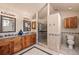 Bright bathroom featuring a double vanity and a glass enclosed shower at 2673 S Cook St, Denver, CO 80210