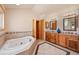Relaxing bathroom featuring a large tub and a double vanity at 2673 S Cook St, Denver, CO 80210