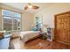Bedroom features hardwood floors, and a large window with backyard view at 2673 S Cook St, Denver, CO 80210
