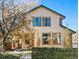 Charming two-story home with a stucco exterior, stone accents, a well-kept lawn, and a welcoming front porch at 2673 S Cook St, Denver, CO 80210