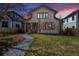 Charming home featuring a stucco facade, a well-manicured lawn and inviting stone pathway at 2673 S Cook St, Denver, CO 80210