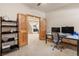 Bright home office featuring wood-trimmed doors, ceiling fan, and modern desk setup at 2673 S Cook St, Denver, CO 80210