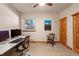 Inviting home office with a workspace and a Pikes Peak print, all in a naturally lit setting at 2673 S Cook St, Denver, CO 80210