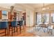 Open-concept kitchen and dining area with bar seating, wood floors, and plenty of natural light at 2673 S Cook St, Denver, CO 80210