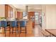 Stylish kitchen with modern appliances, a breakfast bar with blue chairs, and natural wood finishes at 2673 S Cook St, Denver, CO 80210