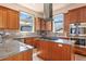 Spacious kitchen features custom cabinets, granite countertops, stainless steel appliances and a center island with cooktop at 2673 S Cook St, Denver, CO 80210