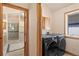 Convenient laundry room with modern washer and dryer, wooden cabinets and tile floors at 2673 S Cook St, Denver, CO 80210