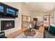 Living area with a fireplace, wood floors, exercise area, and comfortable seating at 2673 S Cook St, Denver, CO 80210