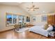 Sunlit primary bedroom featuring vaulted ceilings, hardwood floors, and ample natural light at 2673 S Cook St, Denver, CO 80210