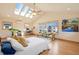 Bright primary bedroom with skylights, vaulted ceilings, and a comfortable seating area at 2673 S Cook St, Denver, CO 80210