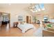 Spacious primary bedroom with vaulted ceiling, skylights, and hardwood floors at 2673 S Cook St, Denver, CO 80210