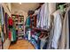 Walk-in closet providing ample storage with built-in shelving and hanging rods at 2673 S Cook St, Denver, CO 80210