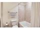 Bathroom with a toilet, shower, decorative towel, and tile floor at 12856 Jasmine St # E, Thornton, CO 80602