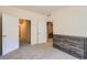 Bedroom with neutral carpet and gray wood dresser at 12856 Jasmine St # E, Thornton, CO 80602
