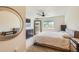 Bedroom with ceiling fan, window and mirror at 12856 Jasmine St # E, Thornton, CO 80602