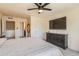 Bedroom featuring a large television, ceiling fan, and a modern dresser at 12856 Jasmine St # E, Thornton, CO 80602