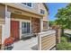 Cozy front porch with seating and decorative flower pot, enhances curb appeal at 12856 Jasmine St # E, Thornton, CO 80602
