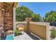 Cozy front porch featuring a comfortable wicker chair with yellow cushion at 12856 Jasmine St # E, Thornton, CO 80602