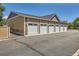 Garage with stone accents, numbered door, and asphalt driveway at 12856 Jasmine St # E, Thornton, CO 80602