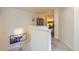 The hallway has decorative art on the walls and a carpeted floor at 12856 Jasmine St # E, Thornton, CO 80602