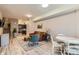 Open-concept living room flows into dining area, showcasing wood floors and modern decor at 12856 Jasmine St # E, Thornton, CO 80602