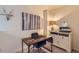 Well-lit office area with stylish desk, comfortable chair, decorative art, and practical storage at 12856 Jasmine St # E, Thornton, CO 80602